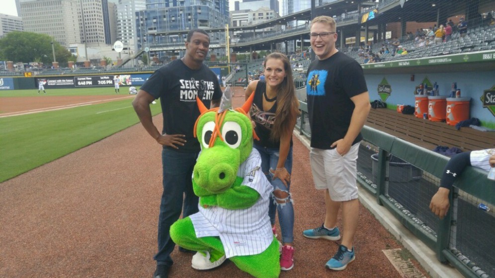Caprice Coleman of Ring of Honor, Kelly Klein of Women of Honor, and Ian Riccaboni, ROH Broadcaster, pose with Homer the Dragon before throwing out the first pitch at the Charlotte Knights game!