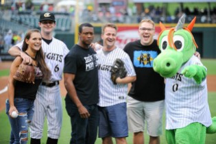 Caprice Coleman of Ring of Honor, Kelly Klein of Women of Honor, and Ian Riccaboni, ROH Broadcaster, with Knights pitcher Connor Walsh and Homer the Dragon after their first pitches